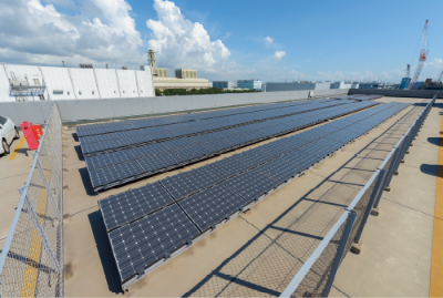 Japanese contractors install solar panels on the Public Works building roof  at Fleet Activities Sasebo, Japan